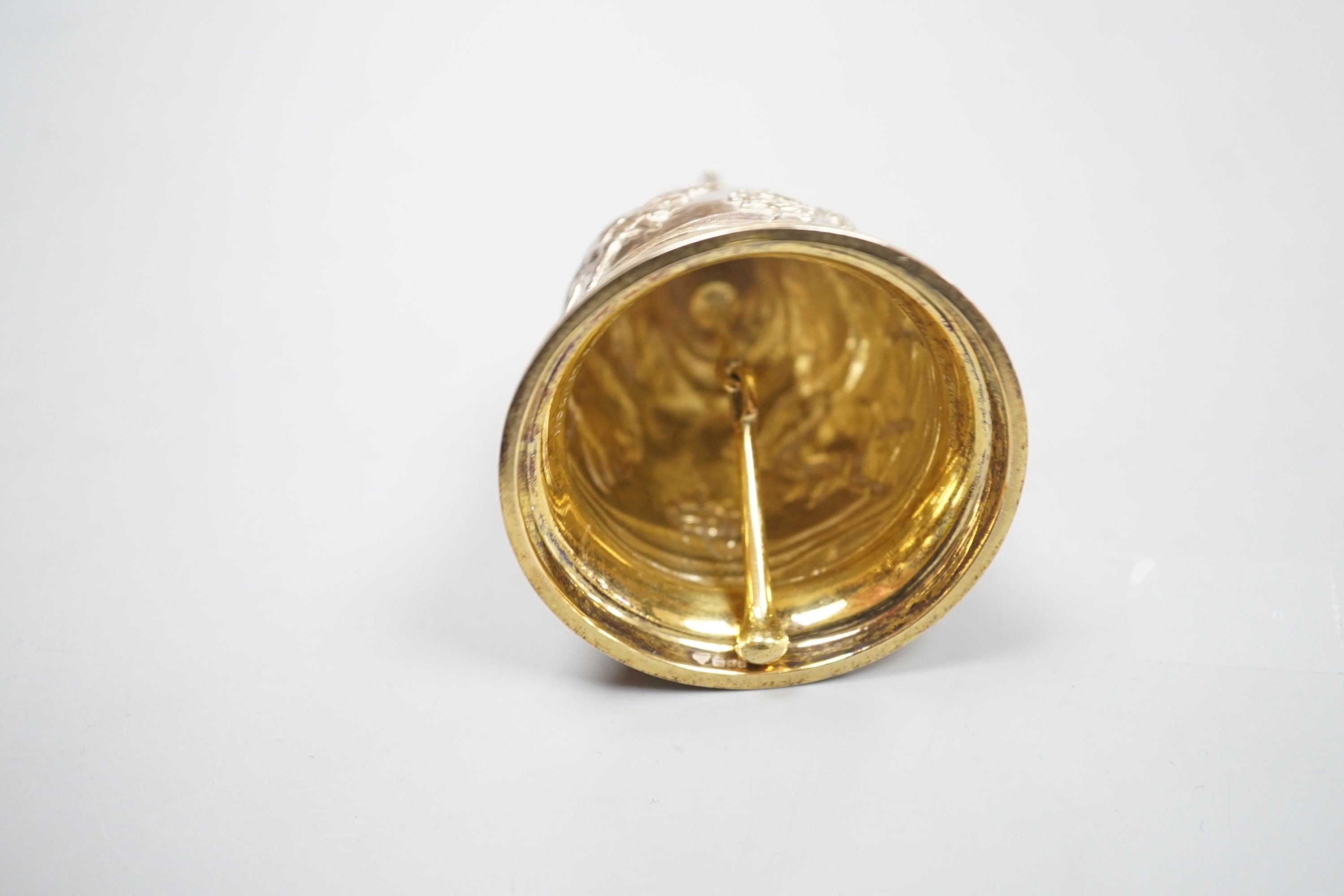 A cased modern embossed silver gilt hand bell, with engraved inscription, 'The Royal Hong Kong Jockey Club Centenary, 1884-1984', Garrard & Co, London, 1985, 94mm, 126 grams.